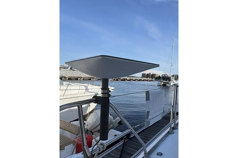 Slide: The Image of 1998 Leopard Catamaran with modern satellite dish, docked at marina. - 58