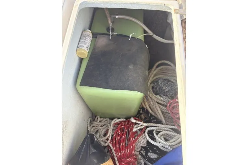 Slide: The Image of Storage compartment on a 1998 Leopard Catamaran with ropes and equipment. - 74