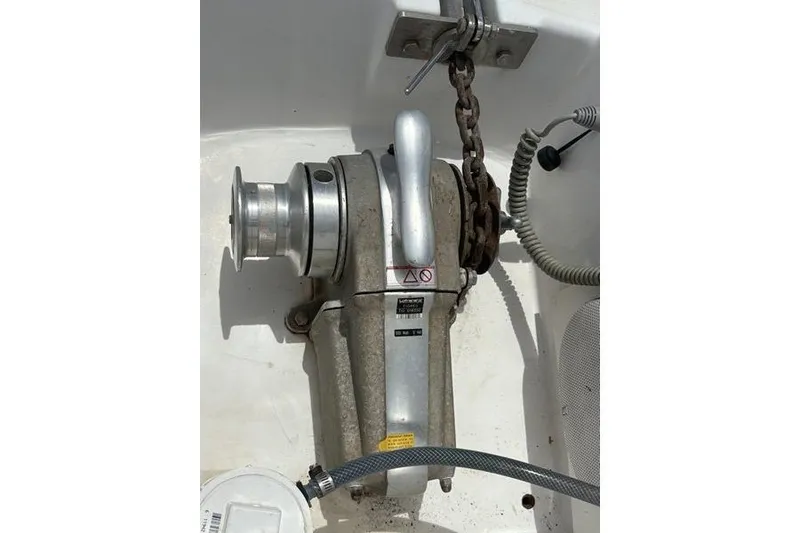 Slide: The Image of Anchor windlass on 1998 Leopard Catamaran deck, featuring chain and handle. - 76