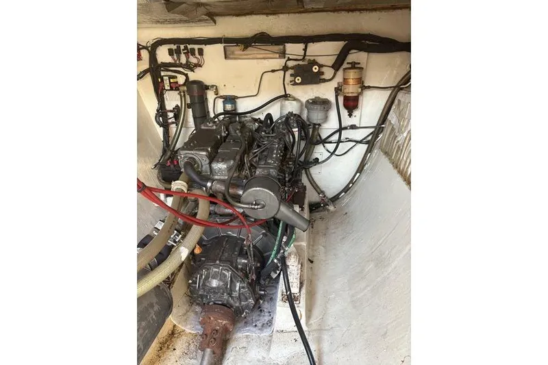 Slide: The Image of Engine compartment of a 1998 Leopard Catamaran, showcasing mechanical components and wiring. - 78
