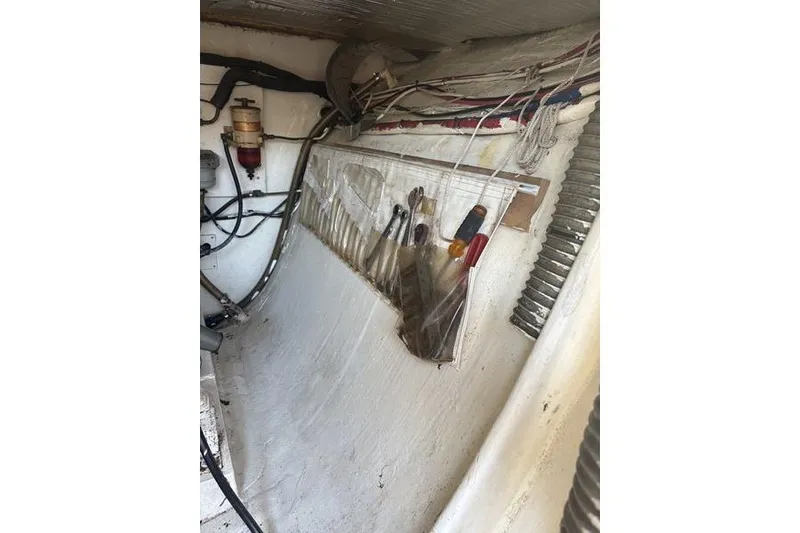 Slide: The Image of Interior of a 1998 Leopard Catamaran showing tools and wiring. - 79