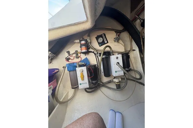 Slide: The Image of 1998 Leopard Catamaran engine compartment with water filtration system and wiring. - 80