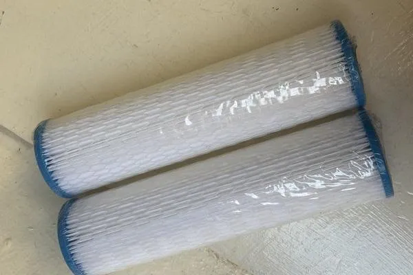 Slide: The Image of Two white cylindrical filters with blue ends on a light surface. - 82