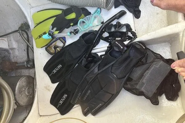 Slide: The Image of Snorkeling gear on 1998 Leopard Catamaran deck, featuring fins, masks, and snorkels. - 83