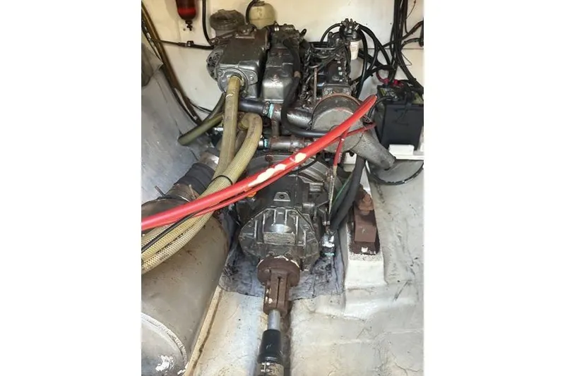 Slide: The Image of Engine compartment of a 1998 Leopard Catamaran with visible hoses and wiring. - 85