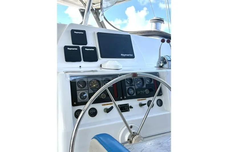 Slide: The Image of Helm of 1998 Leopard Catamaran with Raymarine navigation equipment and steering wheel. - 9