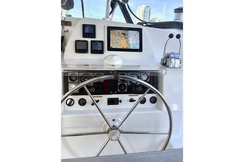 Slide: The Image of Helm of 1998 Leopard Catamaran with navigation instruments and steering wheel. - 90