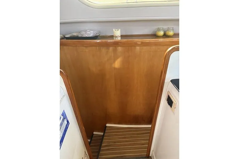 Slide: The Image of Interior of a 1998 Leopard Catamaran with wooden stairs and decorative items. - 93