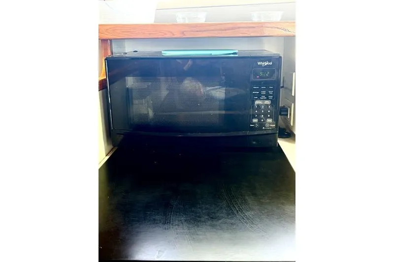 Slide: The Image of Black Whirlpool microwave on a Leopard Catamaran, 1998 model. - 94