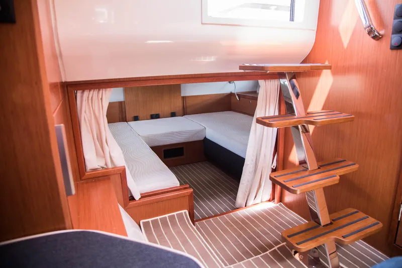 Slide: The Image of 2023 Keizer 42 yacht interior cabin with twin beds and wooden steps. - 25