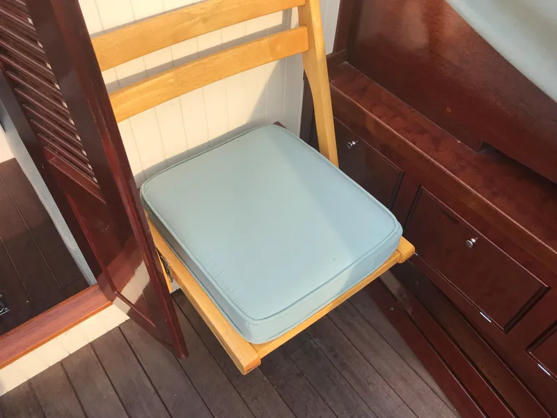 Slide: The Image of Wooden chair with light blue cushion on a classic 2002 Jesperson/Zimmer Design boat. - 13
