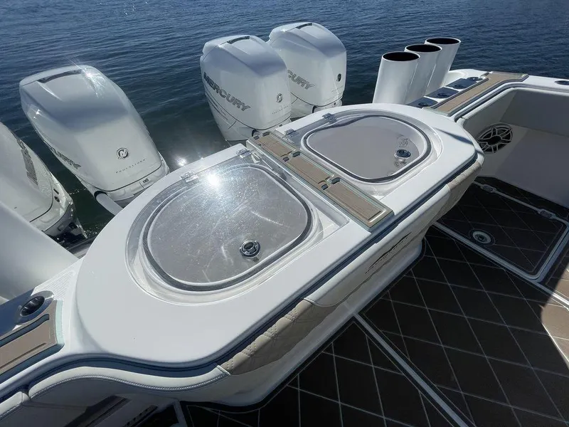 Slide: The Image of 2019 Invincible 40 Catamaran with rod holders and twin outboard engines. - 12
