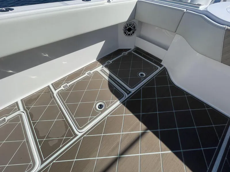 Slide: The Image of 2019 Invincible 40 Catamaran deck with storage compartment and safety warning. - 15