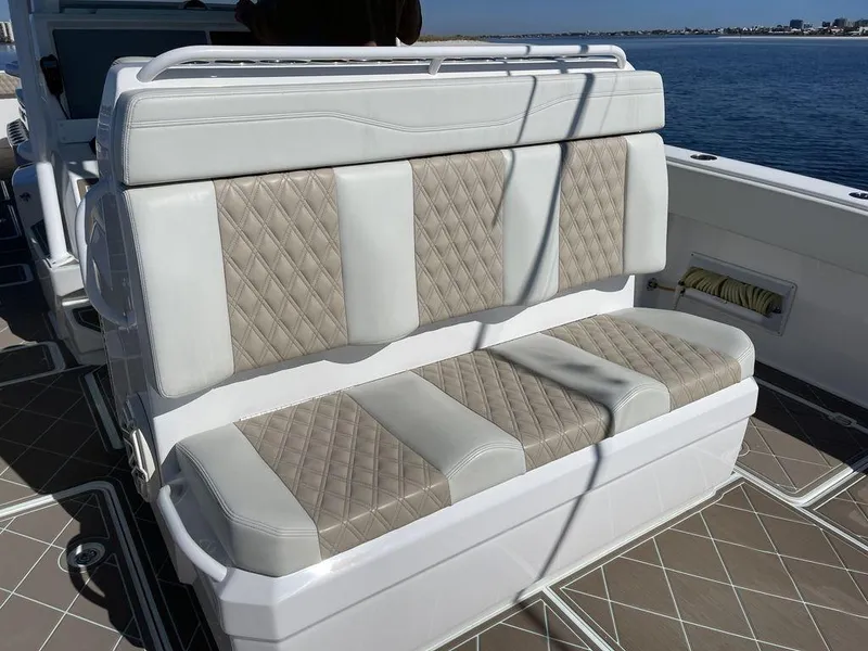 Slide: The Image of Open storage compartment on a 2019 Invincible 40 Catamaran with cushioned seating. - 18