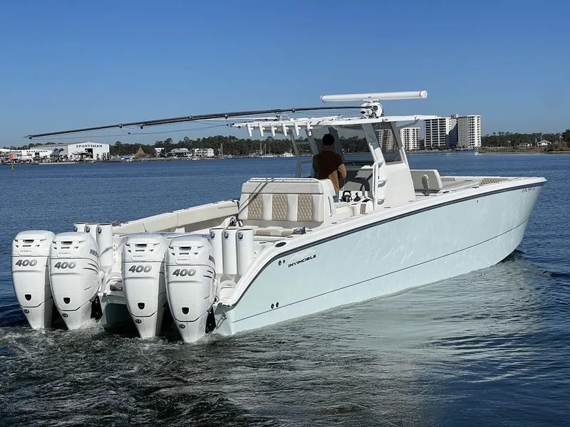 Slide: The Image of 2019 Invincible 40 Catamaran with quad 400 engines cruising on calm waters. - 2