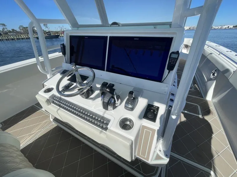 Slide: The Image of 2019 Invincible 40 Catamaran helm station with dual screens and controls - 23