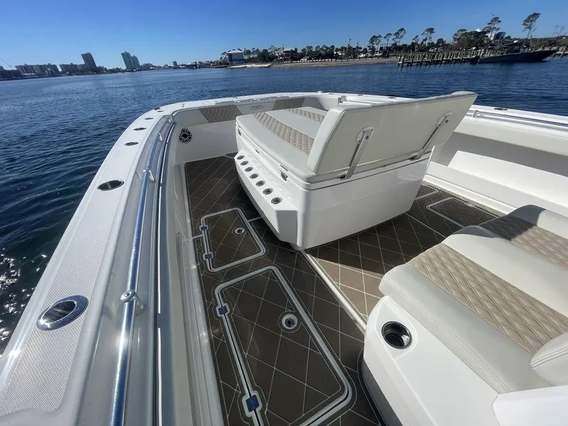 Slide: The Image of 2019 Invincible 40 Catamaran interior with seating, ocean view, and bridge in the background. - 26