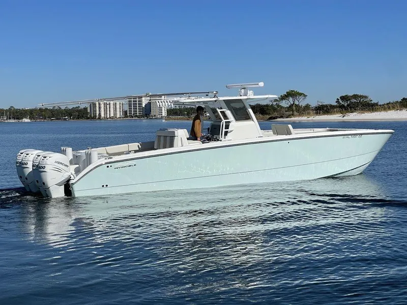 Slide: The Image of 2019 Invincible 40 Catamaran cruising on calm waters near a sandy shoreline. - 5
