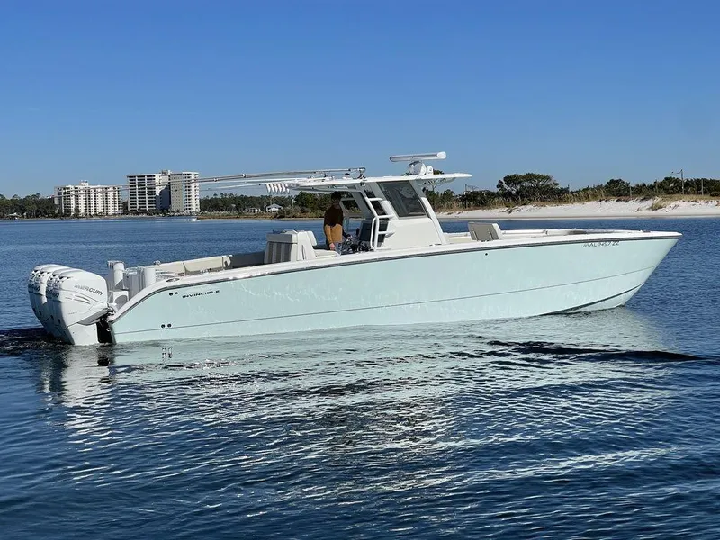Slide: The Image of 2019 Invincible 40 Catamaran on water with buildings and bridge in background. - 6