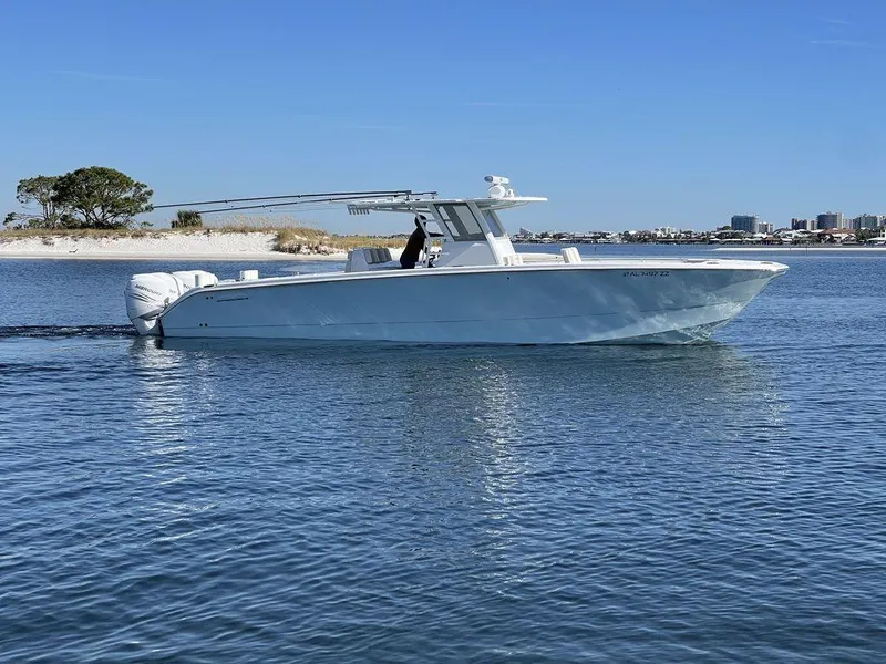 Slide: The Image of 2019 Invincible 40 Catamaran cruising on calm waters near a bridge and buildings. - 7