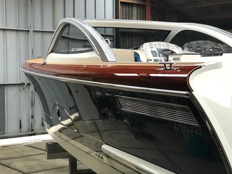 Slide: The Image of 2025 Keizer 42 luxury yacht in a storage facility. - 2