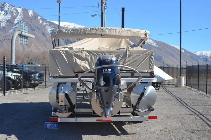 Slide: The Image of 2022 Veranda VF20F4 pontoon boat with 115 HP engine, parked with mountain backdrop. - 15