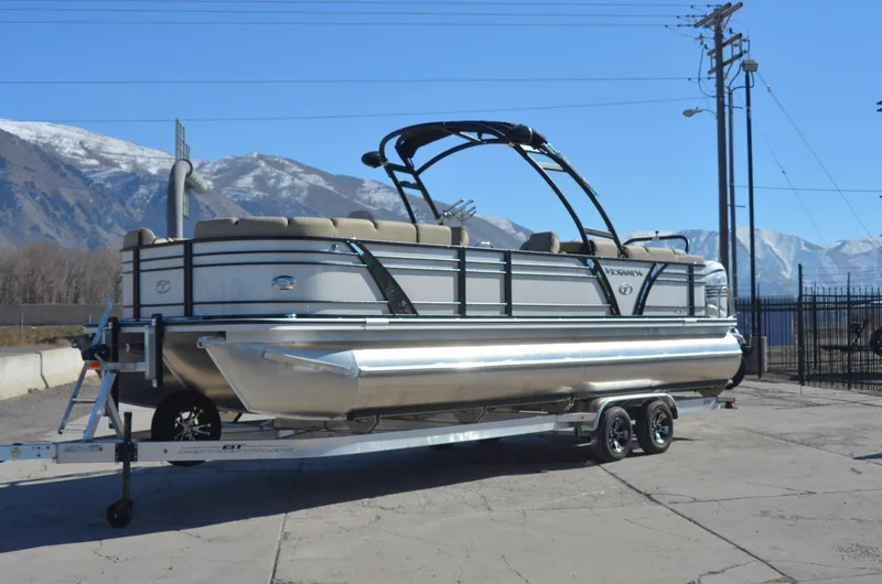 Slide: The Image of 2022 Veranda VF20F4 pontoon boat on trailer with mountain backdrop. - 2