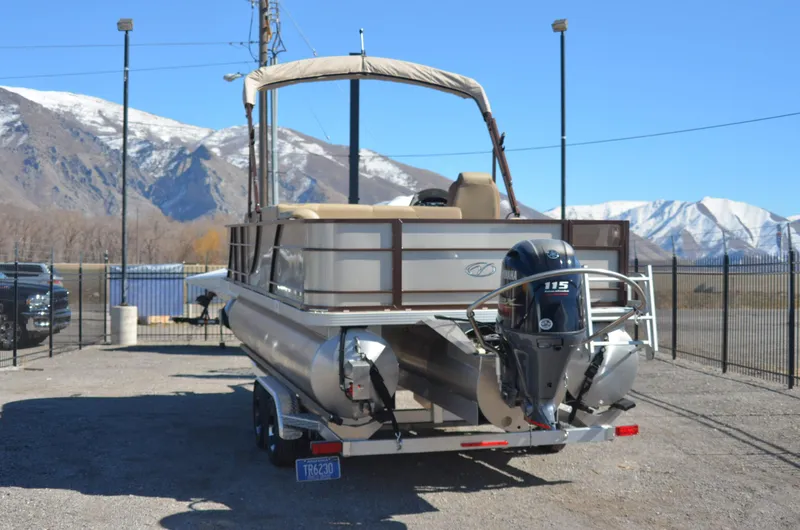 Slide: The Image of 2022 Veranda VF20F4 pontoon boat with 115 HP motor, parked with mountain backdrop. - 6