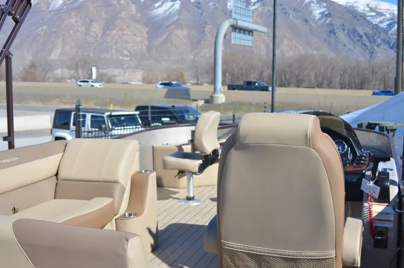 Slide: The Image of 2022 Veranda VF20F4 pontoon boat with beige seating, mountain backdrop. - 8