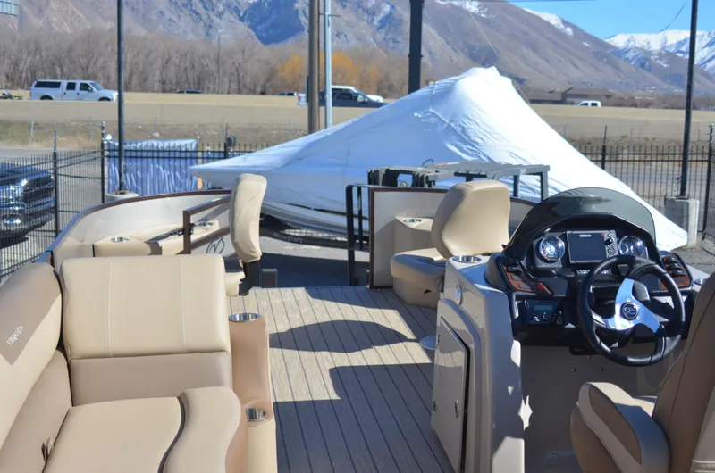 Slide: The Image of 2022 Veranda VF20F4 pontoon boat with beige seating and modern dashboard. - 9