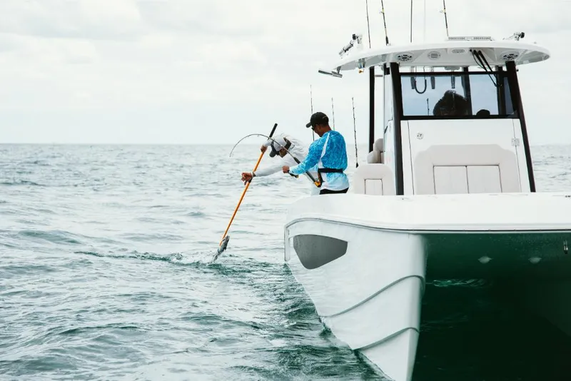 Slide: The Image of 2023 Aquila 28 Molokai boat with person fishing in open water. - 10