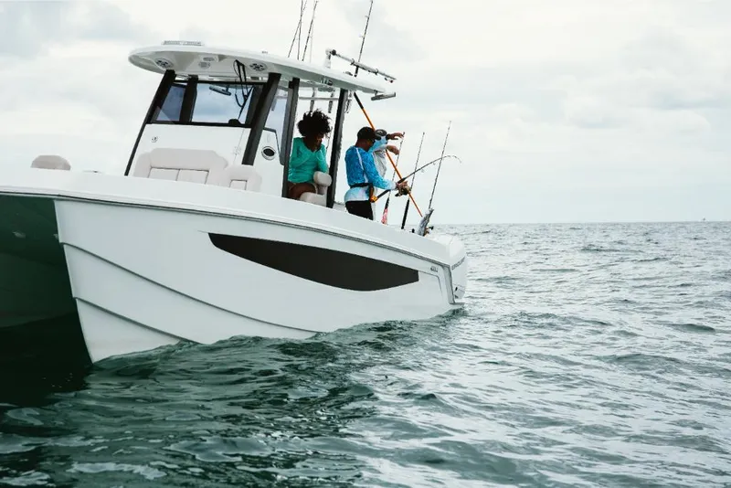 Slide: The Image of 2023 Aquila 28 Molokai boat with people fishing on the ocean. - 12