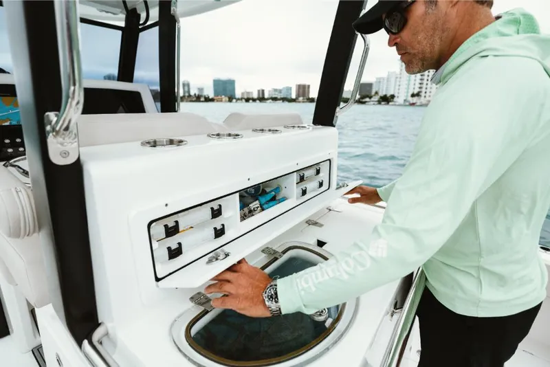 Slide: The Image of Man operating the control panel on a 2023 Aquila 28 Molokai boat. - 19