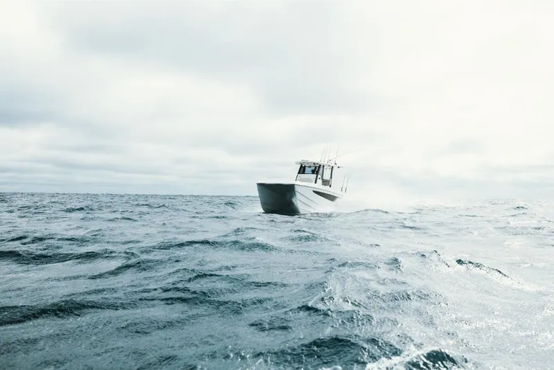 Slide: The Image of 2023 Aquila 28 Molokai boat cruising on open water. - 22