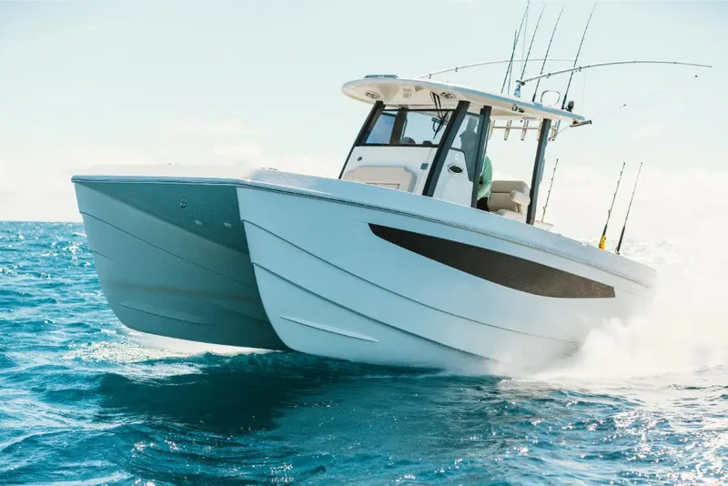 Slide: The Image of 2023 Aquila 28 Molokai catamaran cruising on open water. - 24