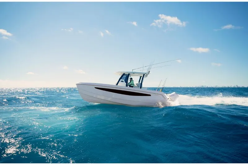Slide: The Image of 2023 Aquila 28 Molokai boat cruising on open blue ocean. - 25