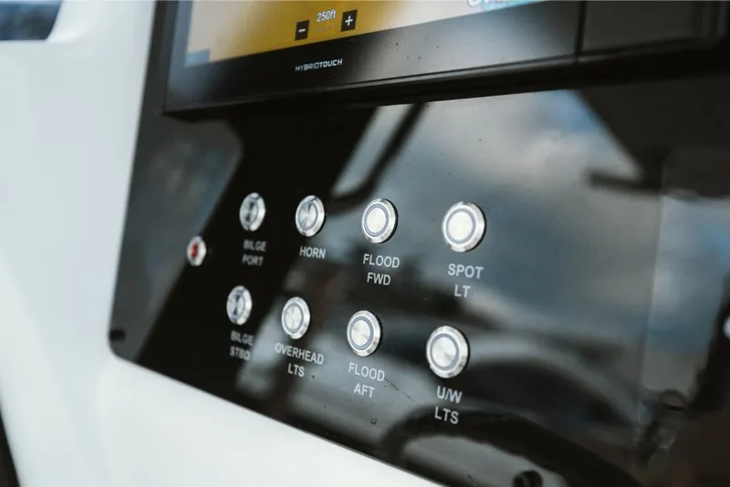 Slide: The Image of Control panel of 2023 Aquila 28 Molokai boat with various function buttons. - 28
