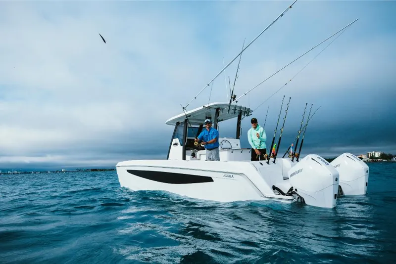 Slide: The Image of 2023 Aquila 28 Molokai boat on the water with two people fishing. - 3