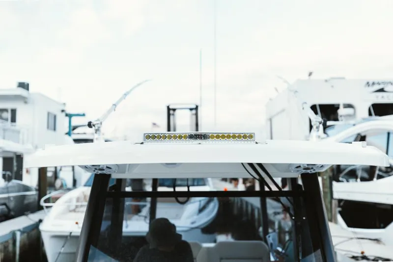 Slide: The Image of 2023 Aquila 28 Molokai boat docked at a marina with other boats. - 33