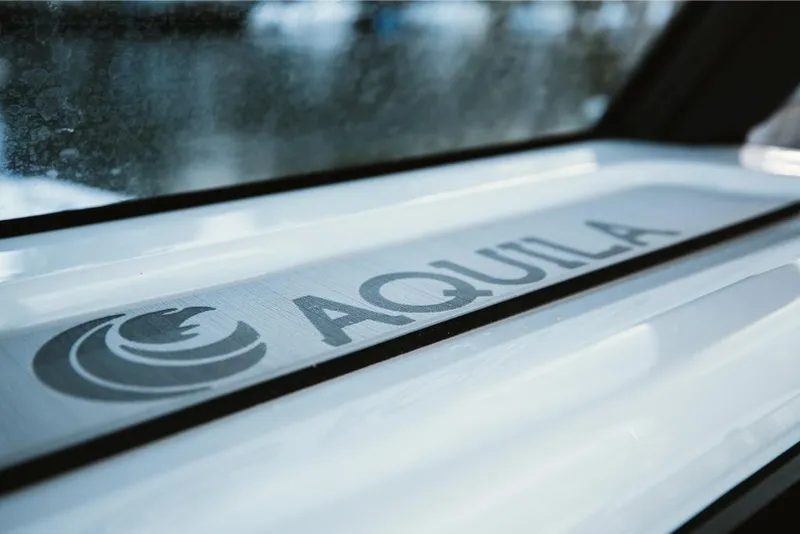 Slide: The Image of Aquila 28 Molokai 2023 logo on boat window. - 37