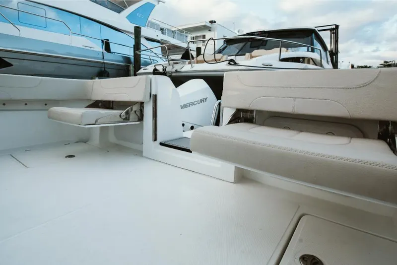 Slide: The Image of 2023 Aquila 28 Molokai boat interior with Mercury engine and beige seating. - 41