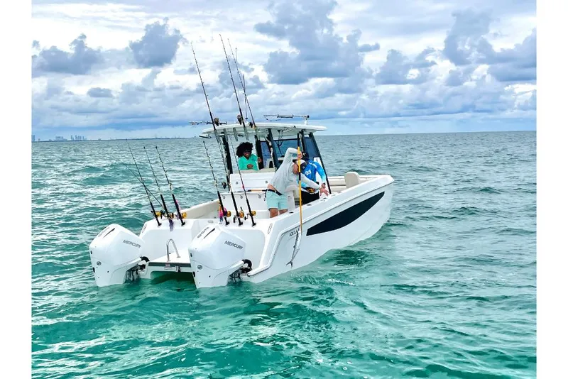 Slide: The Image of 2023 Aquila 28 Molokai boat on the ocean with fishing rods. - 44