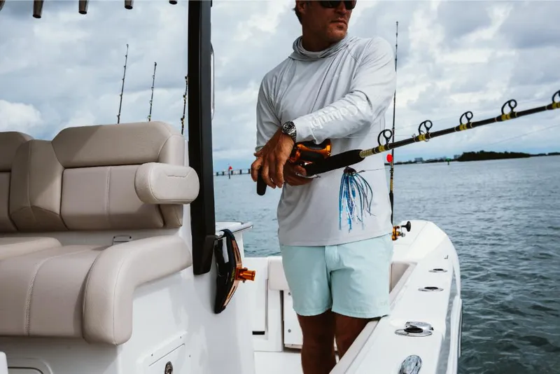 Slide: The Image of Man fishing on a 2023 Aquila 28 Molokai boat. - 6