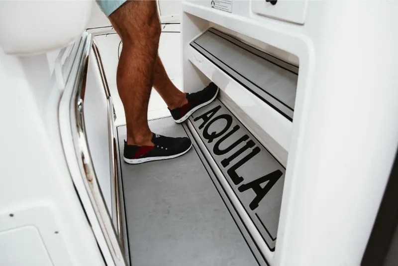 Slide: The Image of Man stepping on Aquila 28 Molokai 2023 boat deck. - 7