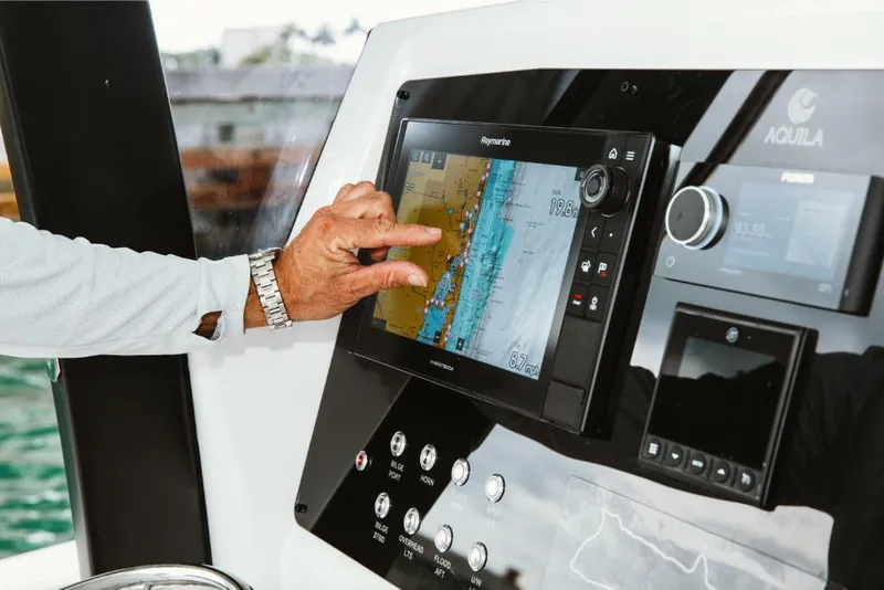Slide: The Image of Person using navigation system on 2023 Aquila 28 Molokai boat. - 8