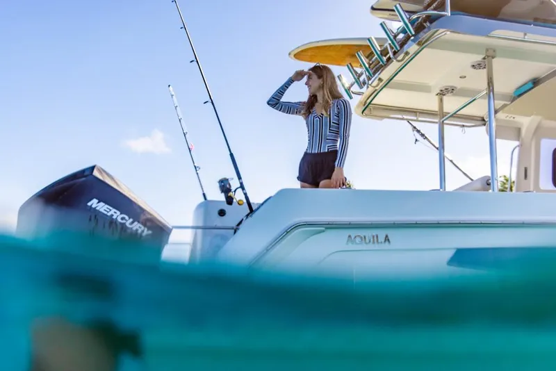 Slide: The Image of 2023 Aquila 28 Molokai Cuddy boat with a person fishing. - 13