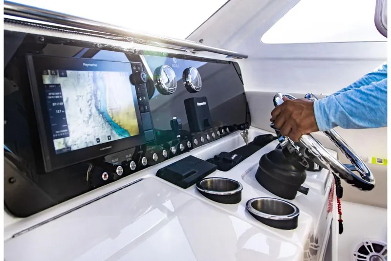 Slide: The Image of Control panel of 2023 Aquila 28 Molokai Cuddy boat with navigation screen. - 16