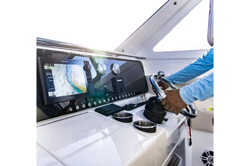 Slide: The Image of 2023 Aquila 28 Molokai Cuddy helm with navigation system and steering wheel. - 18