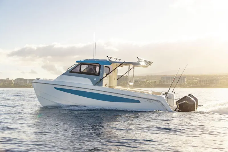 Slide: The Image of 2023 Aquila 28 Molokai Cuddy boat cruising on water. - 5