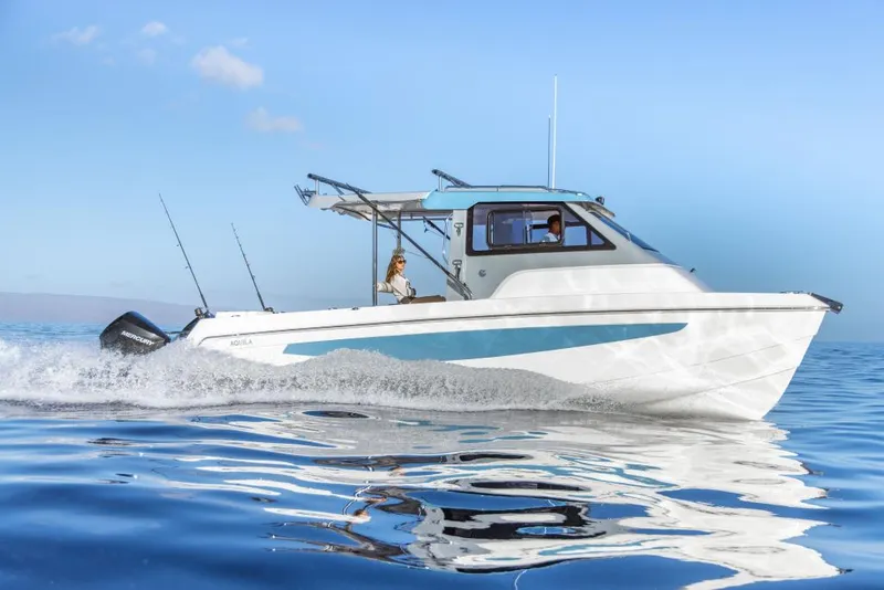 Slide: The Image of 2023 Aquila 28 Molokai Cuddy cruising on calm blue waters. - 8